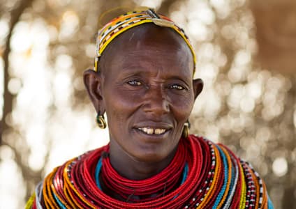 Karamojong woman showcasing traditional beadwork in Uganda