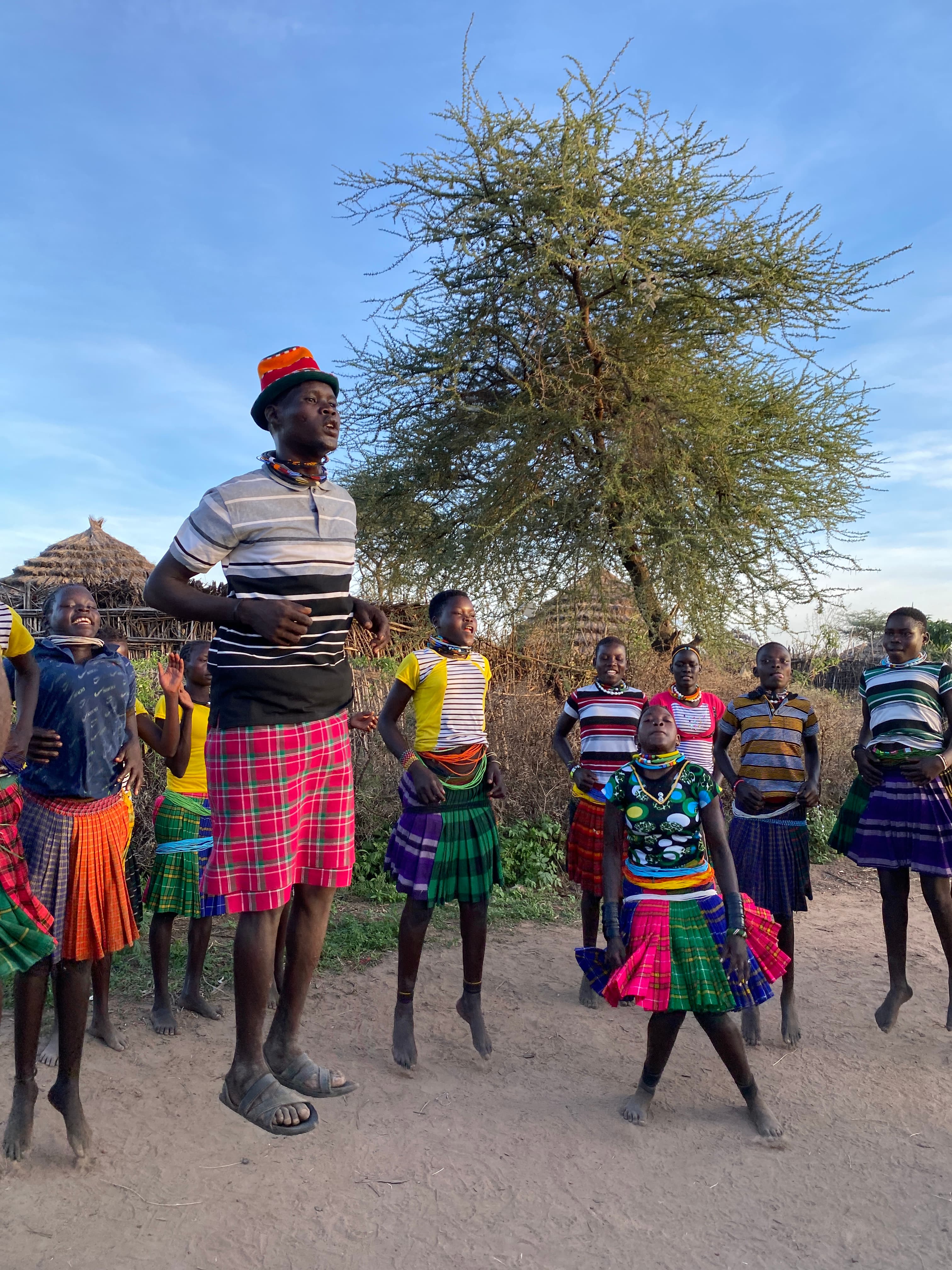 Wide group photo at the Nadunget community cultural gathering at sunset, Moroto District, Uganda